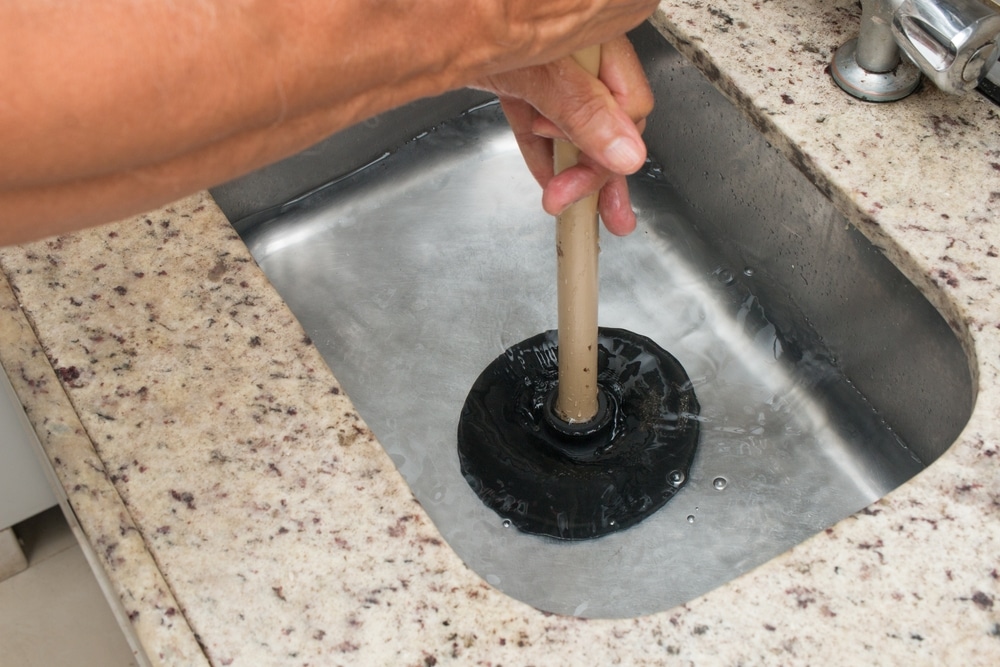 using a plunger to fix clogged drain